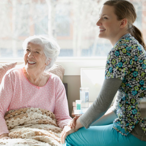 happy senior woman with her caregiver