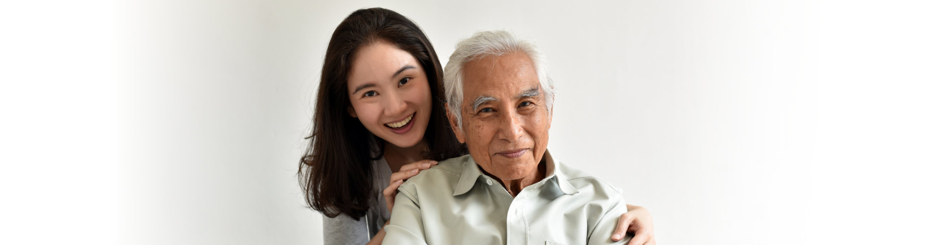 young woman holding senior man in shoulder