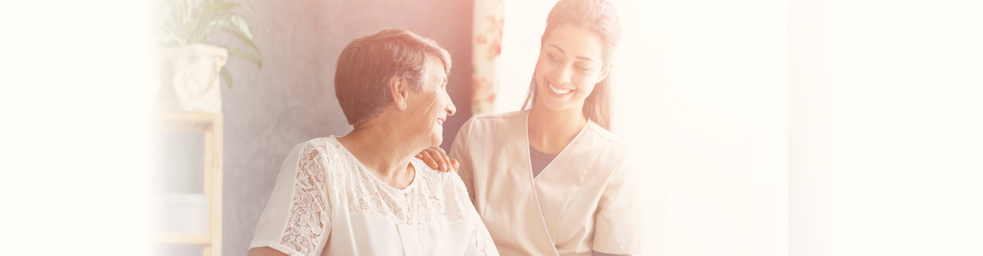 smiling caregiver with senior woman